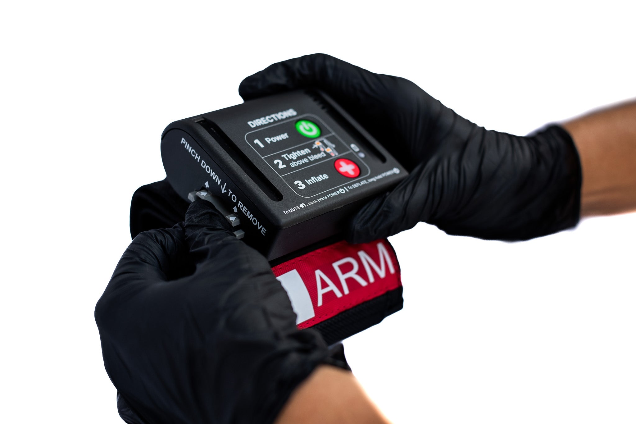 Person wearing black gloves holding an AutoTQ device with 'ARM' branding on a white background
