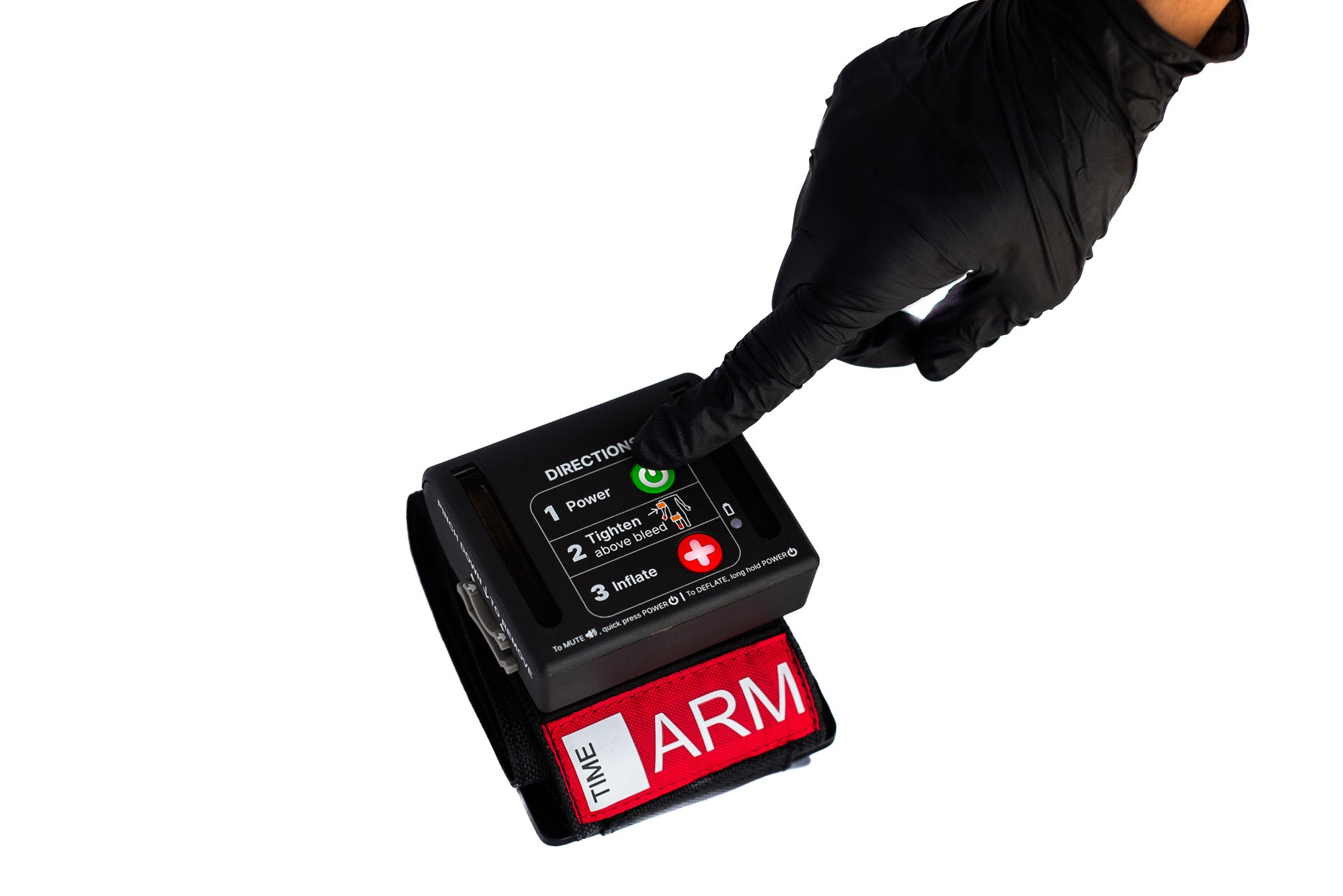 Hand wearing a black glove pressing power button on AutoTQ device with strap labeled 'The ARM' on a white background