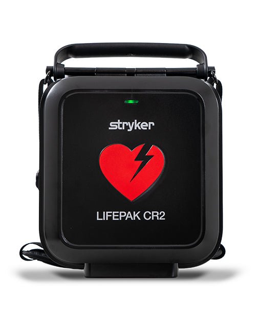 A black Stryker LifePak CR2 portable cardiac monitor device with a carrying handle, featuring a red heart logo with a lightning bolt on the front, set against a plain white background.