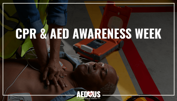 Woman performing CPR on man on the ground with G5 AED next to him.