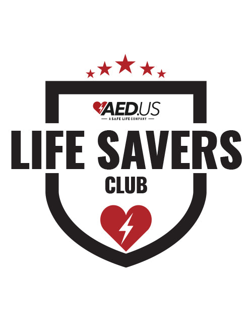 AED.US Life Savers Club logo featuring a black shield outline with bold black text reading ‘LIFE SAVERS CLUB.’ At the top of the shield, the AED.US logo includes a red heart with a lightning bolt. Above the text, five red stars are arranged in an arc. At the bottom of the shield, a red heart with a white lightning bolt is centered.