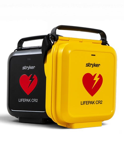 Two Stryker LifePak CR2 emergency defibrillator cases shown on a white background, one in black and one in bright yellow, both with a red heart and lightning bolt logo.