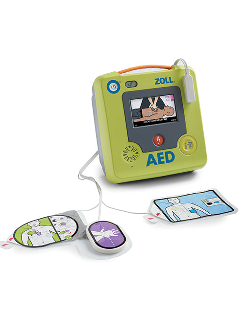 ZOLL AED 3 positioned at an angle with the color screen showing "good compressions" with the pads open and on display